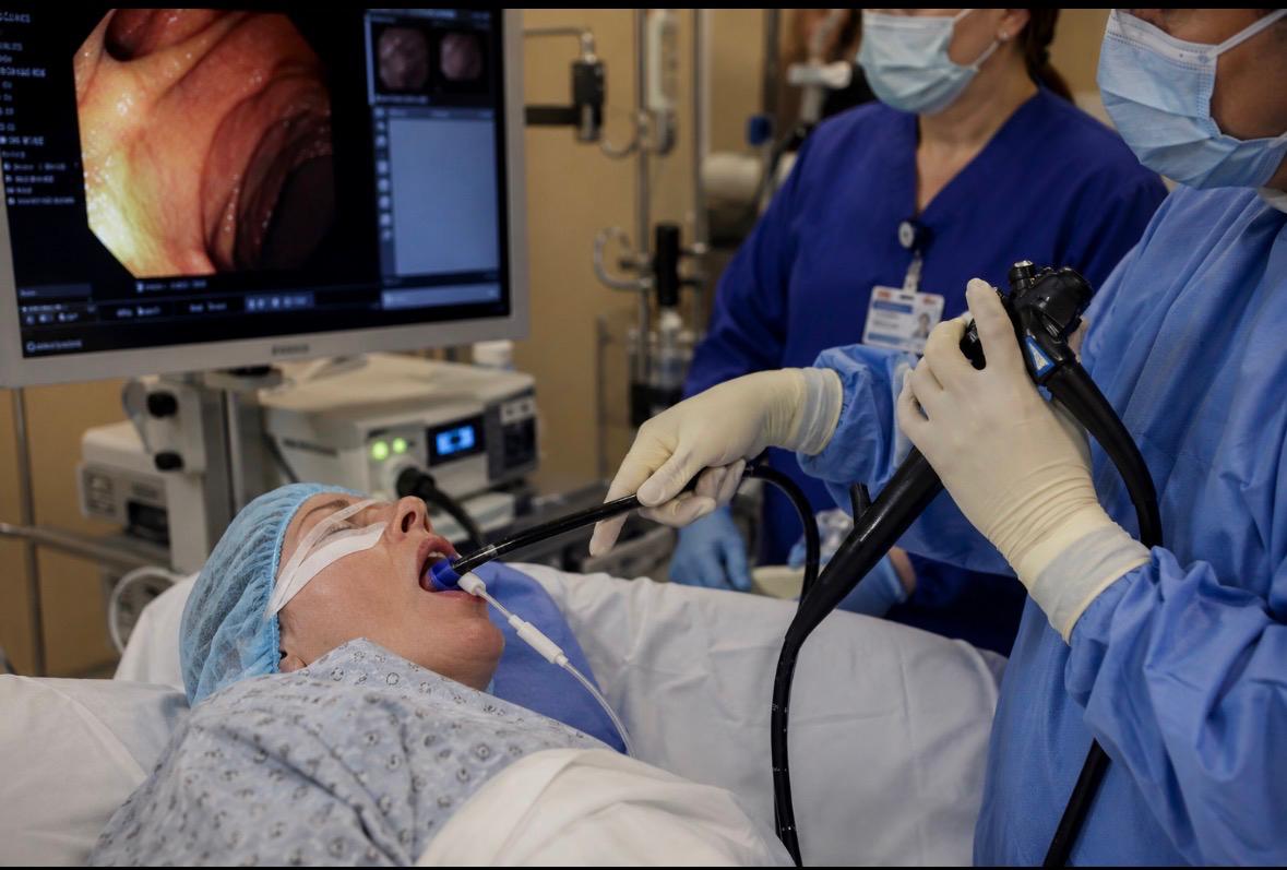 An ERCP procedure showing an endoscope passed through the mouth with the internal view visible on a monitor